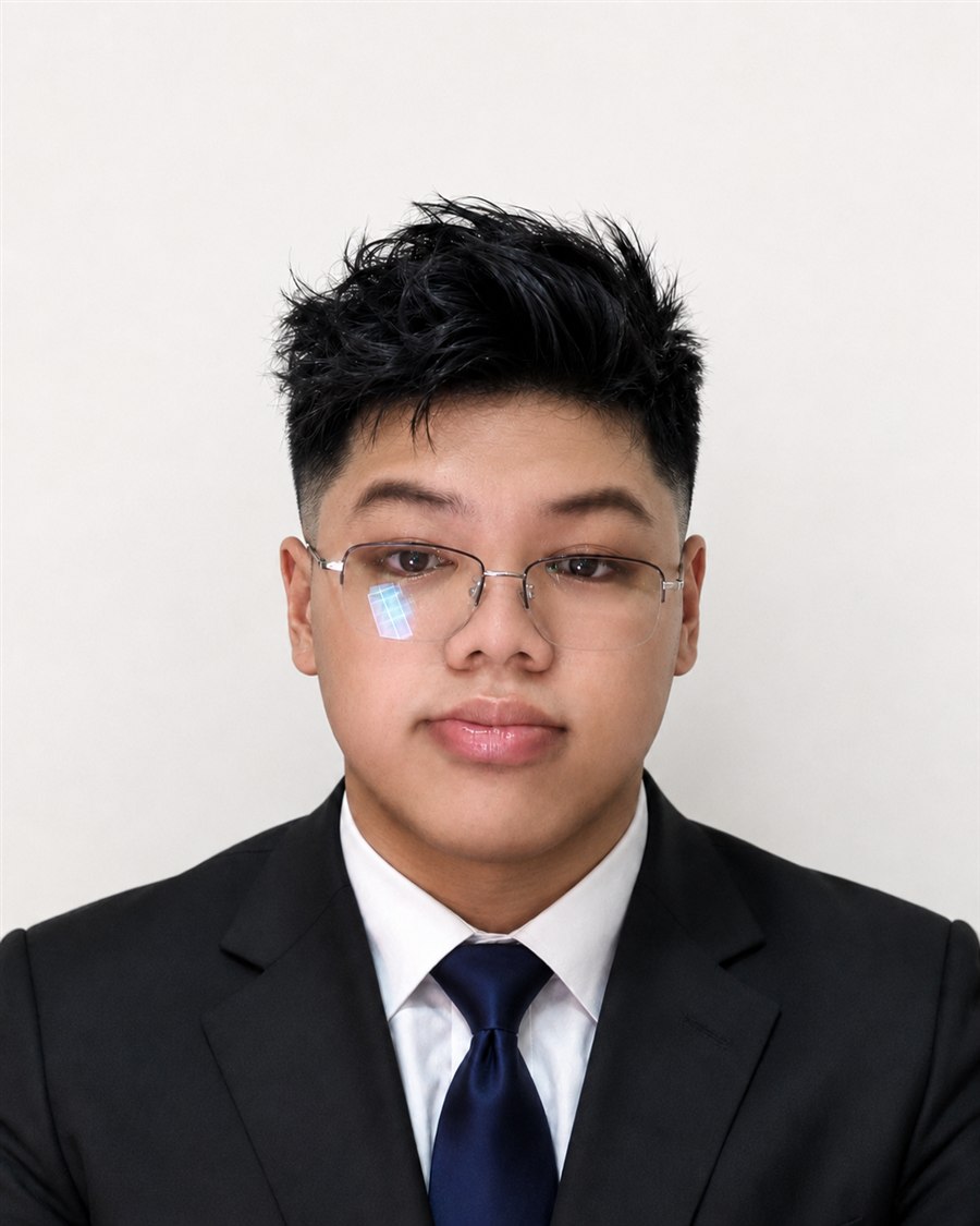 Portrait of John Hendrix Dela Cruz wearing a black suit and navy tie